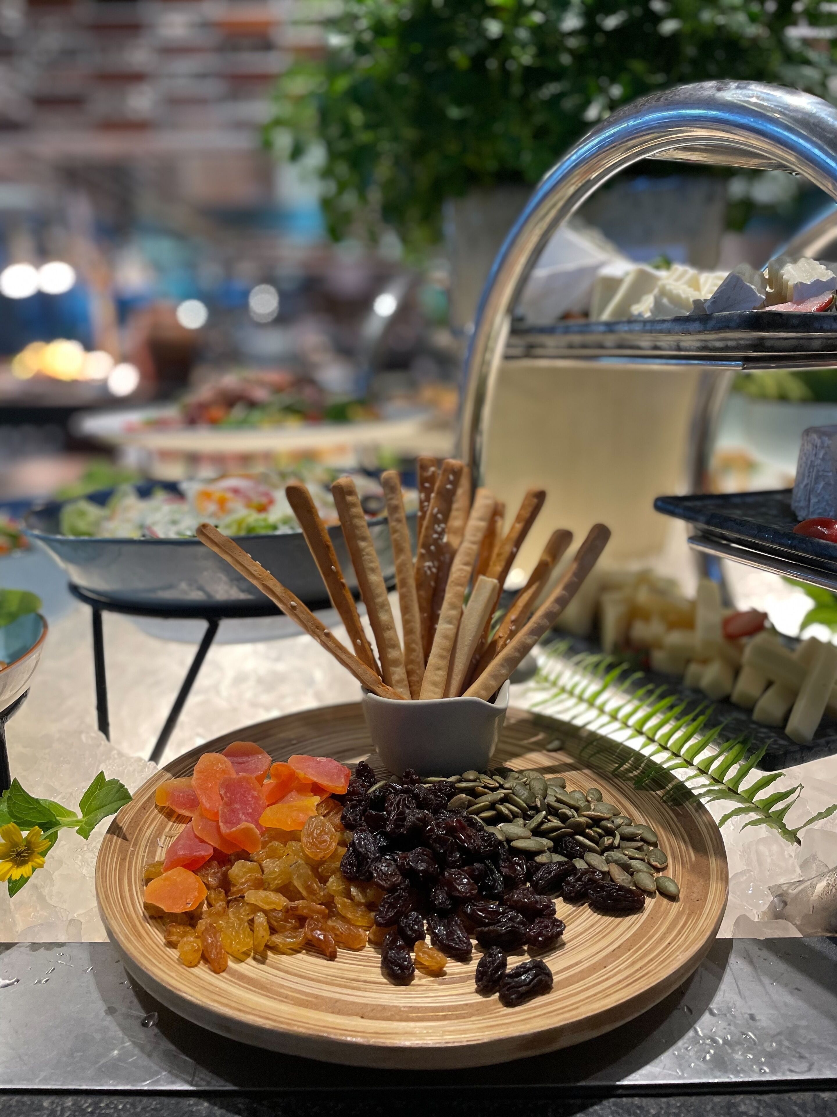 A buffet table with various food items including dried fruits, nuts, and crackers.