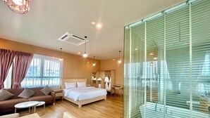 A modern hotel room with a bed, sofa, and dining area. - Siri Oriental Bangkok Hotel (Bangkok)