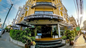 A multi-story hotel with a curved facade, balconies, and a sign reading "Siri Oriental Bangkok Hotel". - Siri Oriental Bangkok Hotel (Bangkok)