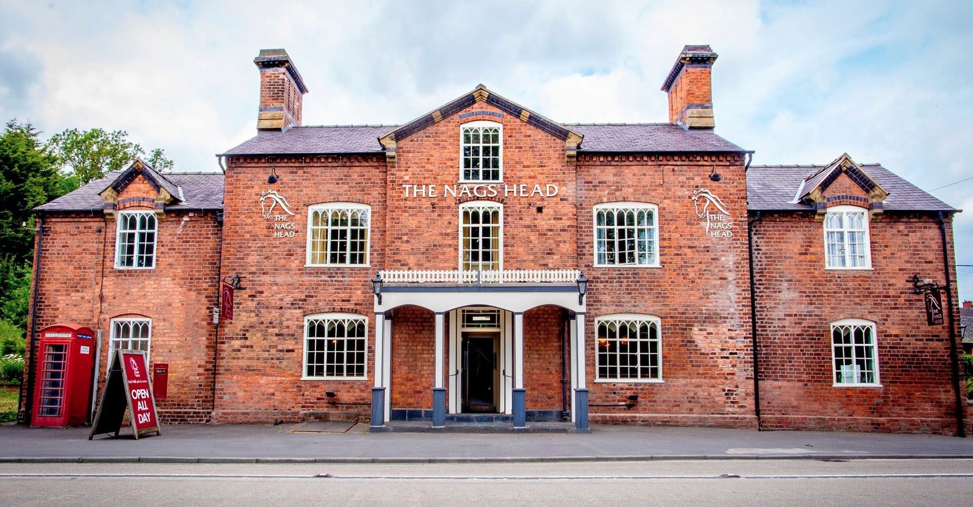 A traditional brick building with the sign "The Nags Head" above the entrance.