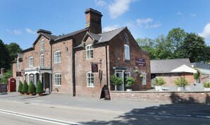 A traditional brick building with a sign reading "The Nags Head."