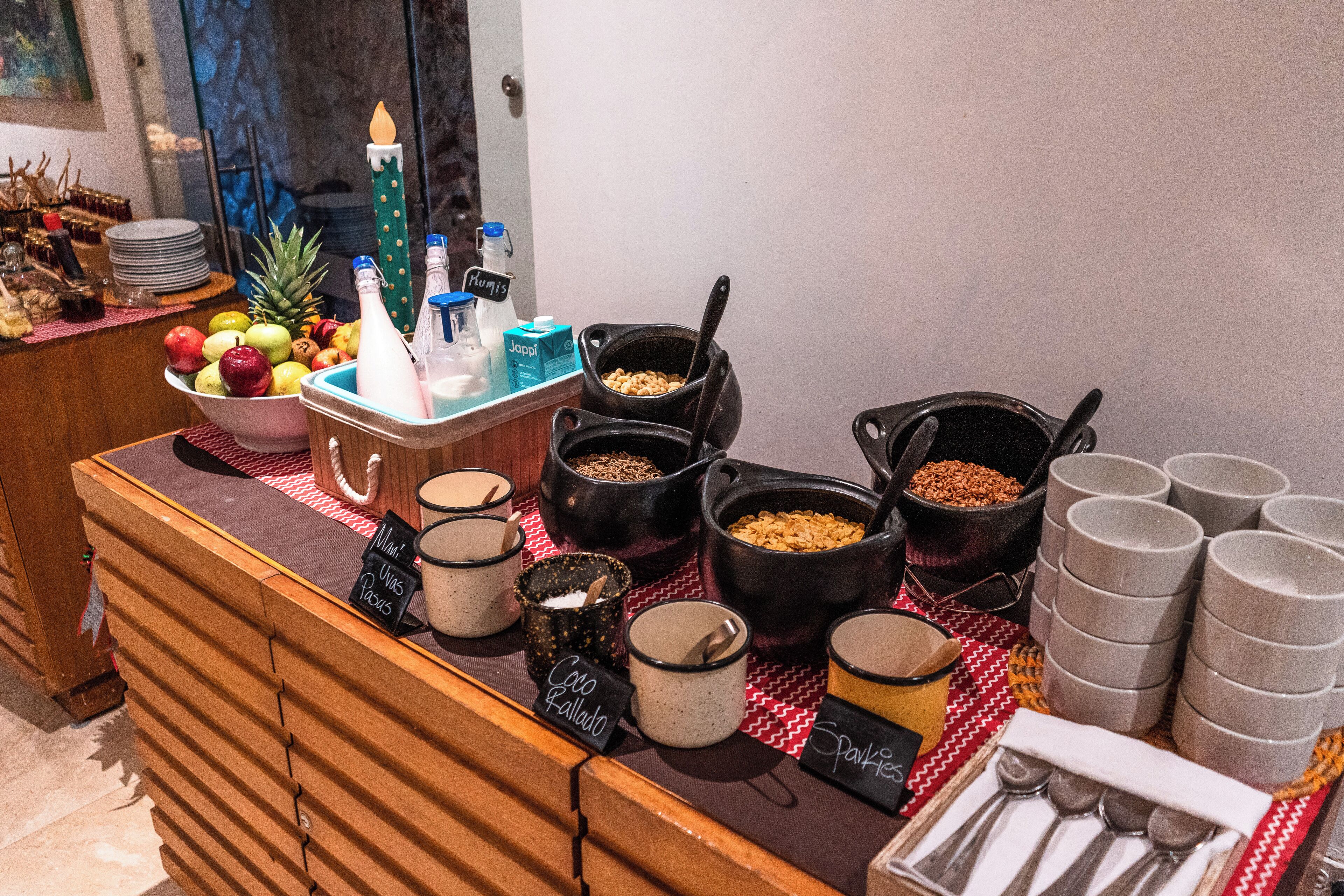 A buffet setup with various food items and serving utensils.