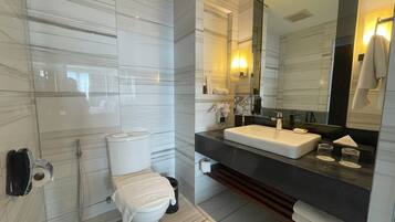 A modern bathroom with a toilet, bidet, and sink.
