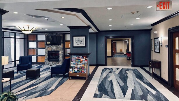A lobby with a fireplace, seating area, and a reception desk. - Comfort Inn & Suites Meriden East (Meriden)