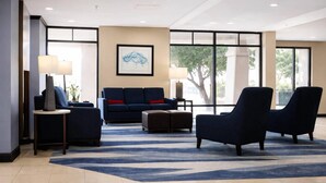 A modern lobby with a sofa, armchairs, a coffee table, and a rug. - Comfort Inn & Suites Meriden East (Meriden)