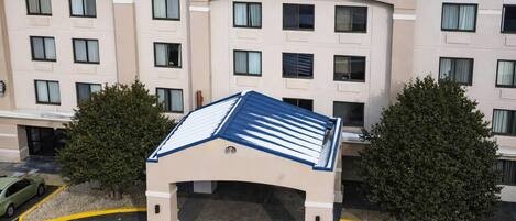 A Comfort Inn & Suites hotel with a central entrance, multiple floors, and a parking area.