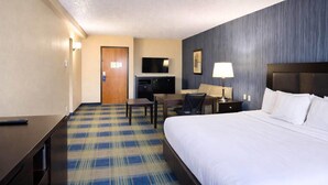 A hotel room with a bed, desk, chair, TV, and a lamp. - Comfort Inn & Suites Meriden East (Meriden)