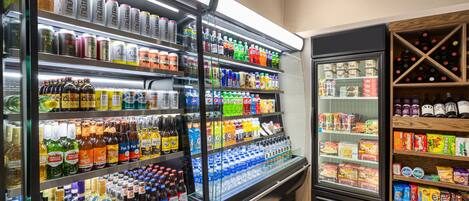 A refrigerated display case with various beverages and snacks.