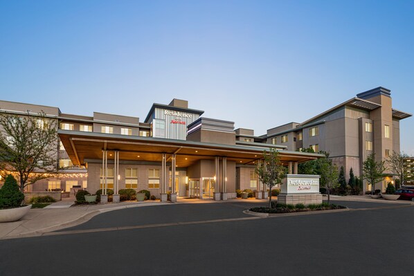 A modern hotel with a prominent entrance, a covered lobby area, and a sign indicating it is part of the Marriott brand. - Residence Inn Denver Cherry Creek (Denver)