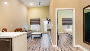 A spacious living area with a kitchen, dining area, and a bedroom. - The Hotel Sync (Bowling Green)