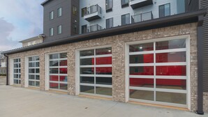 A building with large garage-style windows and a brick facade. - The Hotel Sync (Bowling Green)