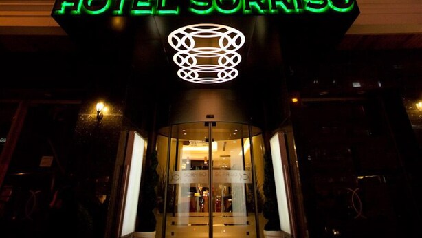 A hotel with a prominent neon sign reading "HOTEL SORRISO" and a modern architectural design. - Sorriso Hotel (Istanbul)