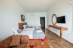 Triple Room, Partial Sea View | Minibar, in-room safe, soundproofing, free WiFi