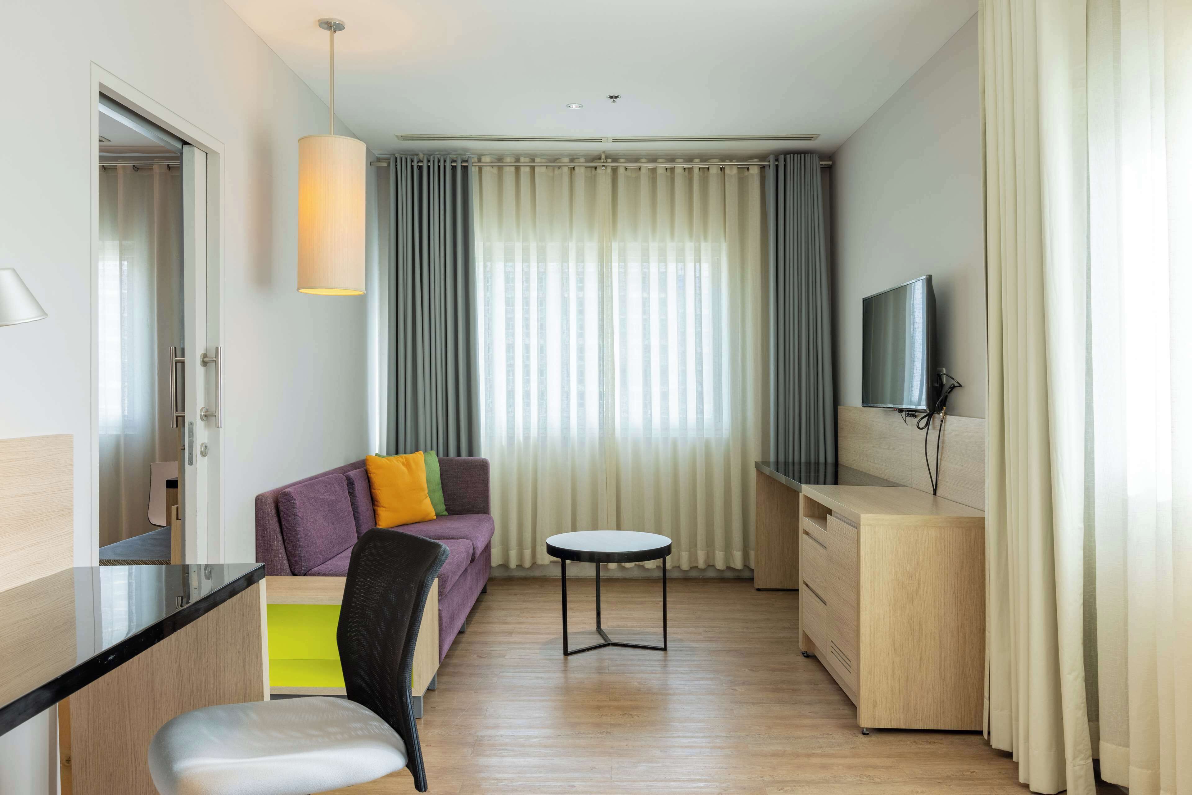 junior suite, 1 king bed, accessible bathtub, city view | minibar, in-room safe, desk, laptop workspace