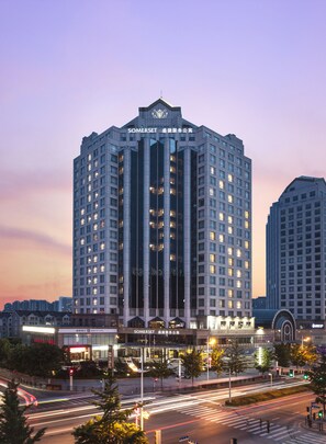A high-rise hotel with multiple floors, large windows, and a prominent entrance at the base. - Somerset Grand Central Dalian (Dalian)