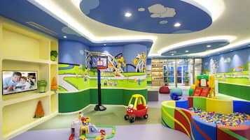 Kids can play and explore in this vibrant play area with a ball pit, slides, and basketball hoop.