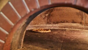 A pizza inside a brick oven. - The Bucks Head (Southampton)