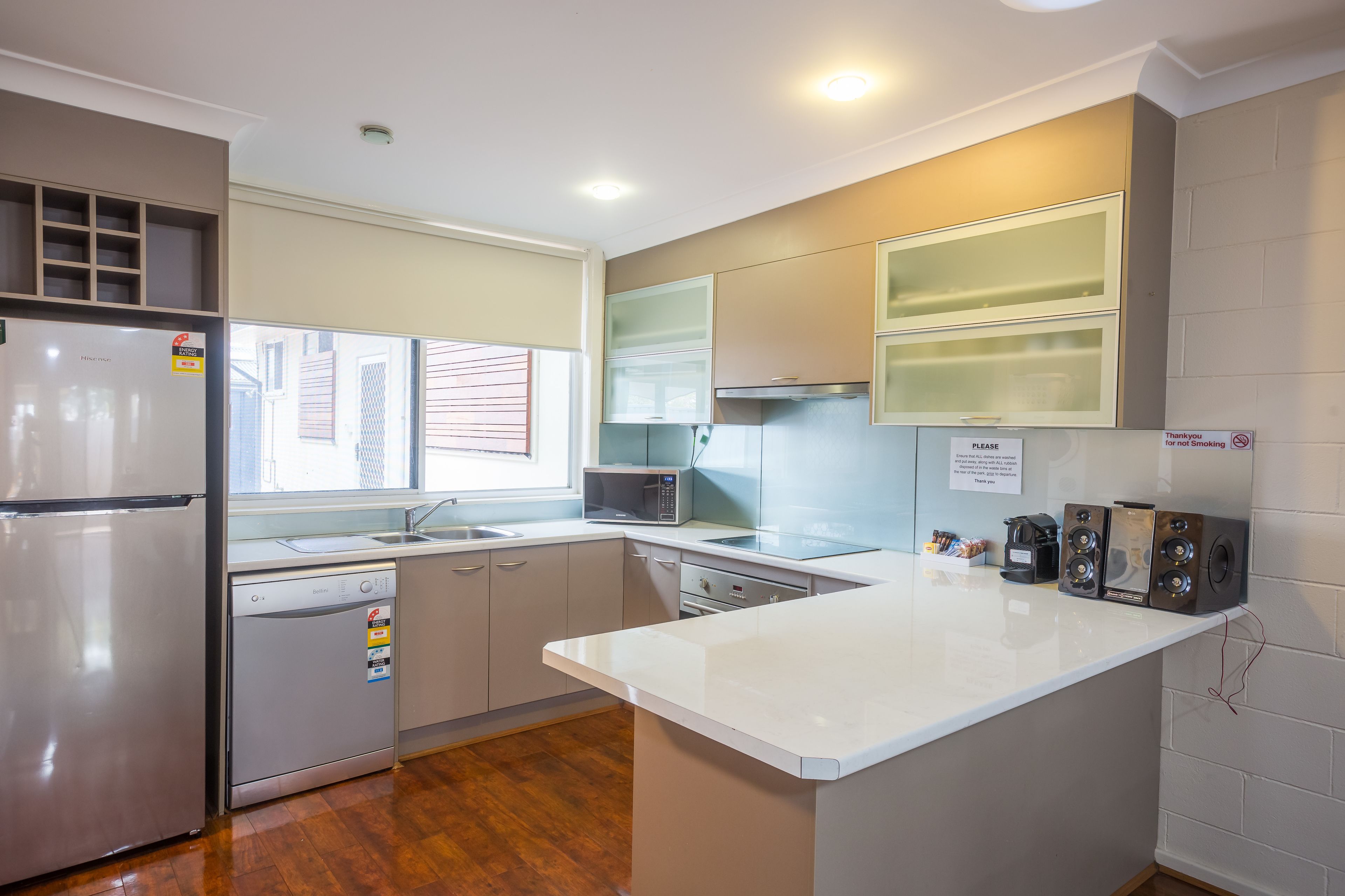 A modern kitchen with a built-in dishwasher, a microwave, and a coffee maker.