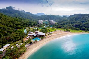 A resort with beachfront accommodations, a pool, and lush greenery. - Pico Sands Hotel (Nasugbu)