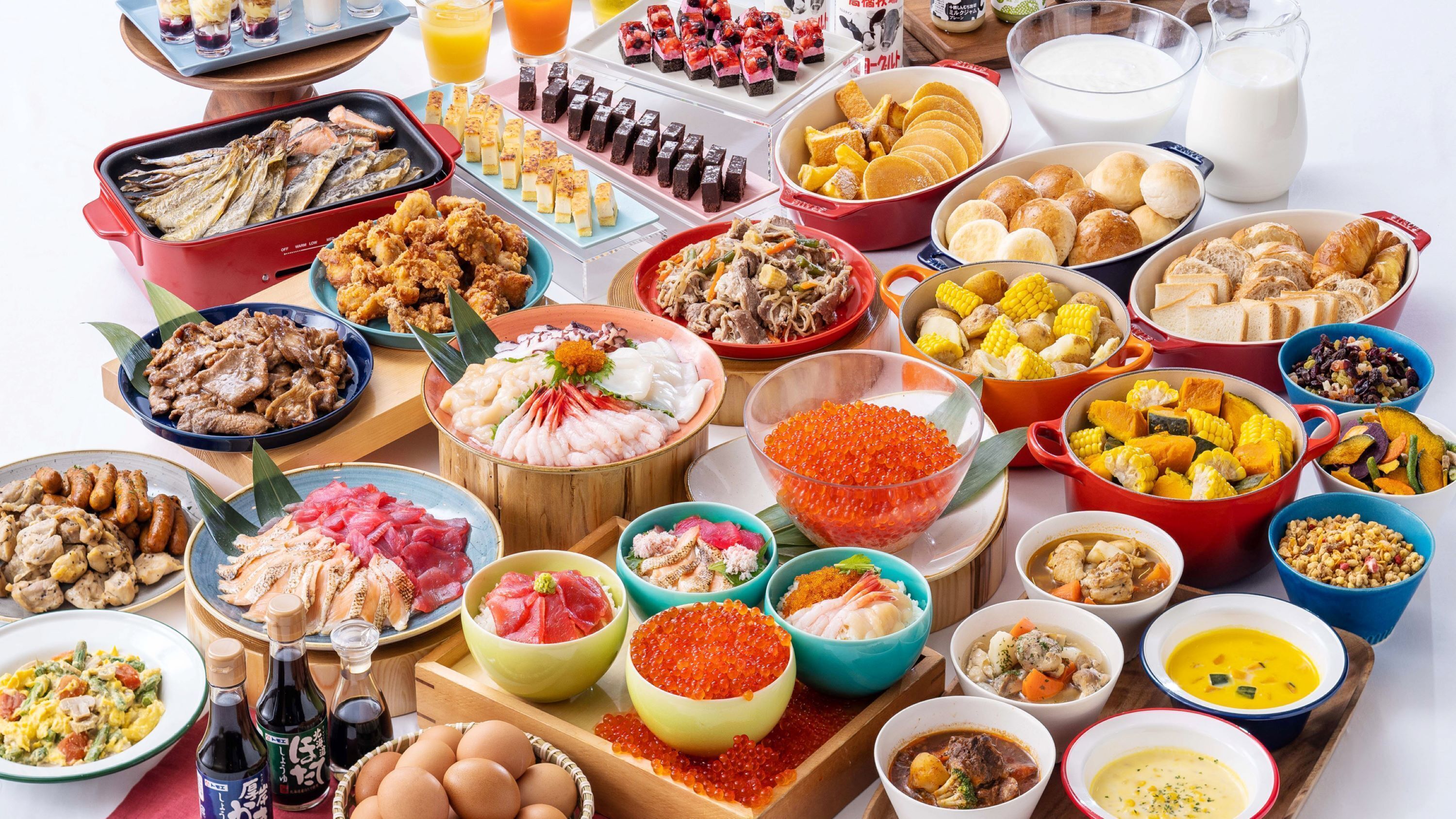 A variety of dishes including seafood, vegetables, and desserts, suggesting a diverse meal selection.