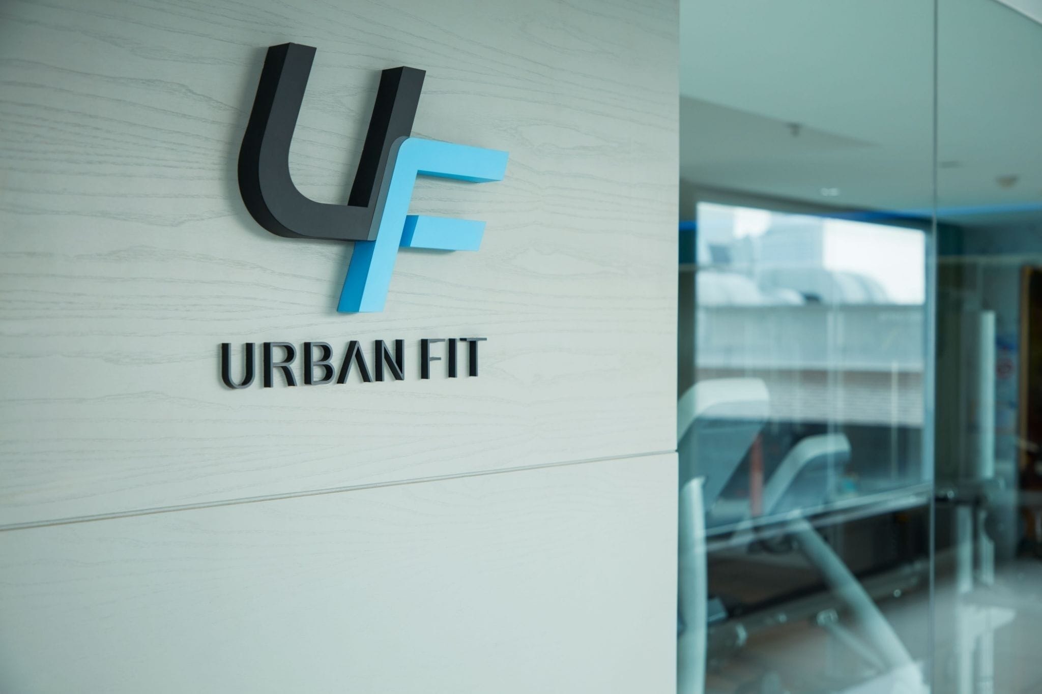 A logo with 'UF' and 'URBAN FIT' on a wall.
