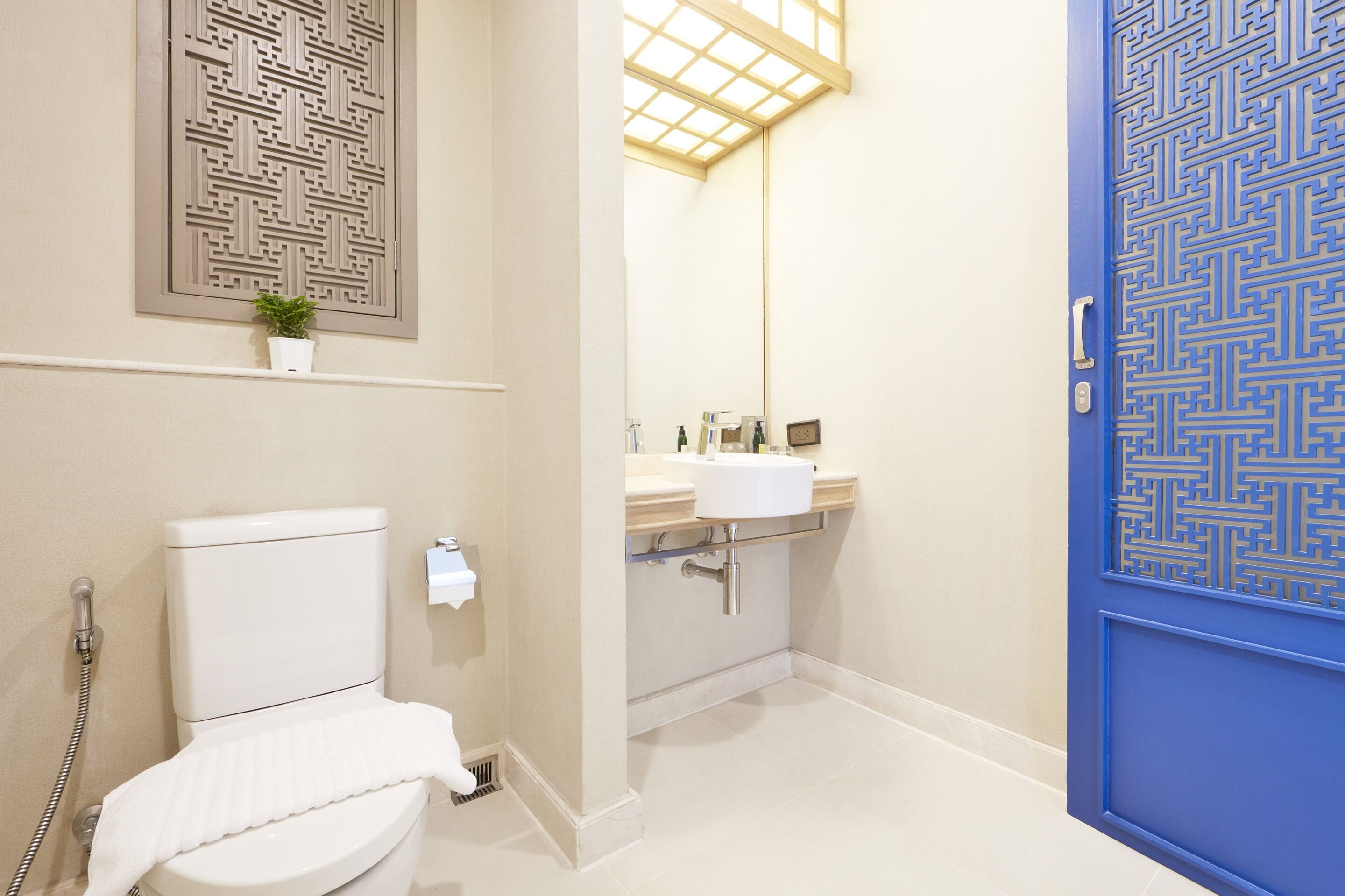 A bathroom with a toilet, sink, and shower.