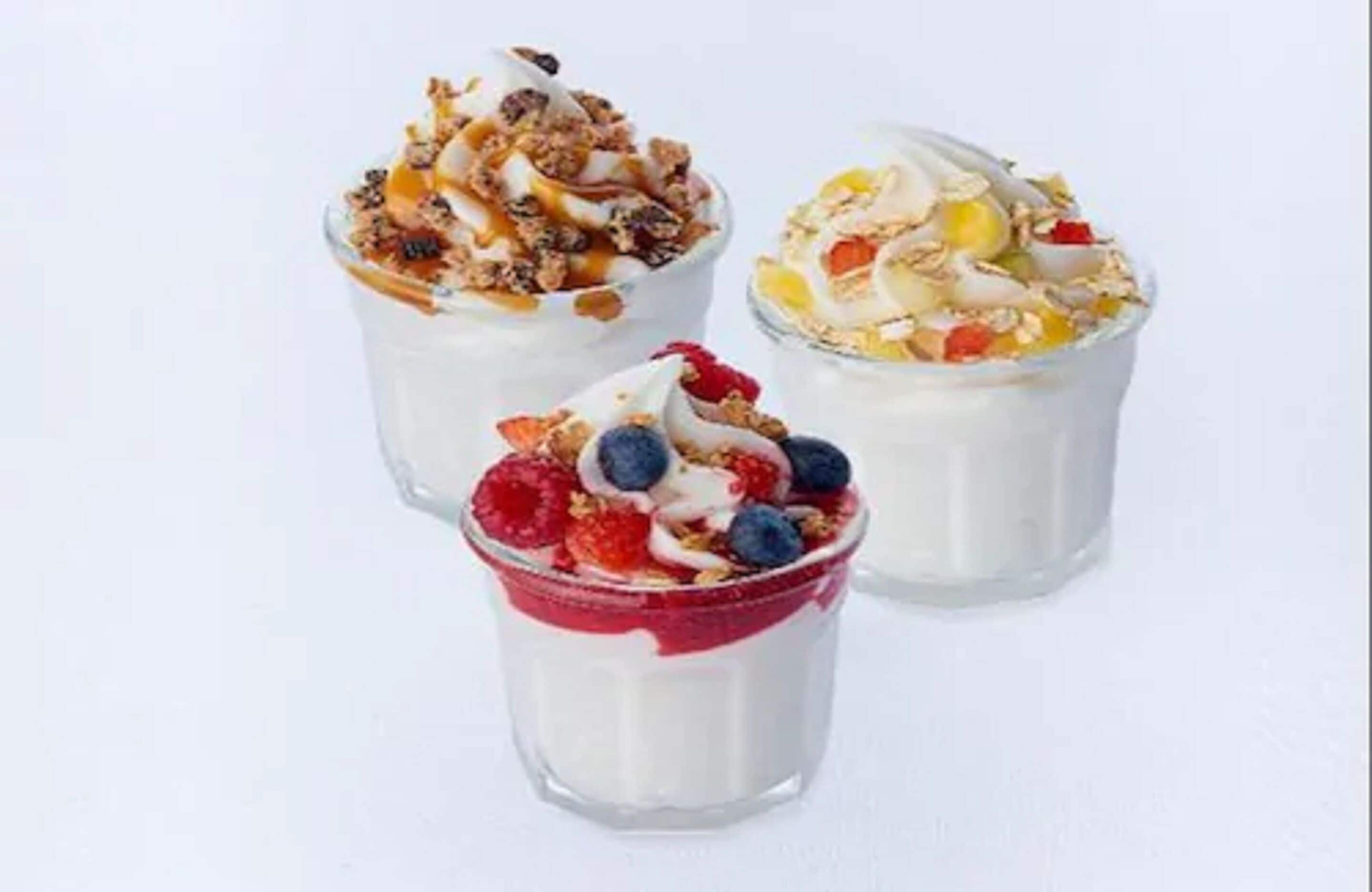 Three yogurt parfaits with different toppings.