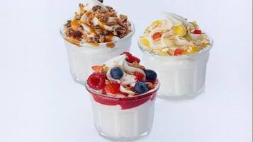 Three yogurt parfaits with different toppings.