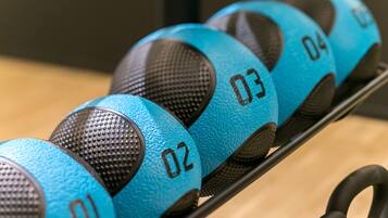 A set of blue and black exercise balls with numbers 01 to 04 on a rack.