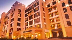 A multi-story hotel with a modern design, featuring balconies and large windows. - Movenpick Hotel Apartments Al Mamzar Dubai (Dubai)