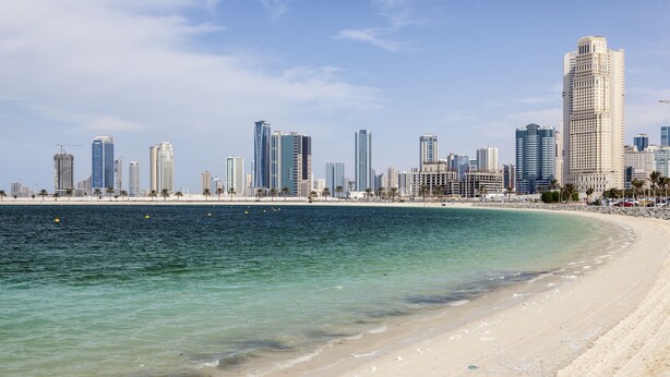 A coastal cityscape with a beach and high-rise buildings. - Movenpick Hotel Apartments Al Mamzar Dubai (Dubai)