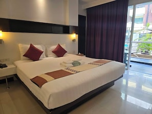 Deluxe Room, Pool Access | 1 bedroom, in-room safe, individually decorated, desk