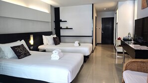 A hotel room with two beds, a desk, a chair, and a television. - Baron Beach Hotel (Pattaya)