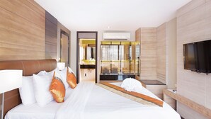 A hotel room with a large bed, a TV mounted on the wall, and a bathroom visible through an open door. - Mida Hotel Ngamwongwan (Nonthaburi)