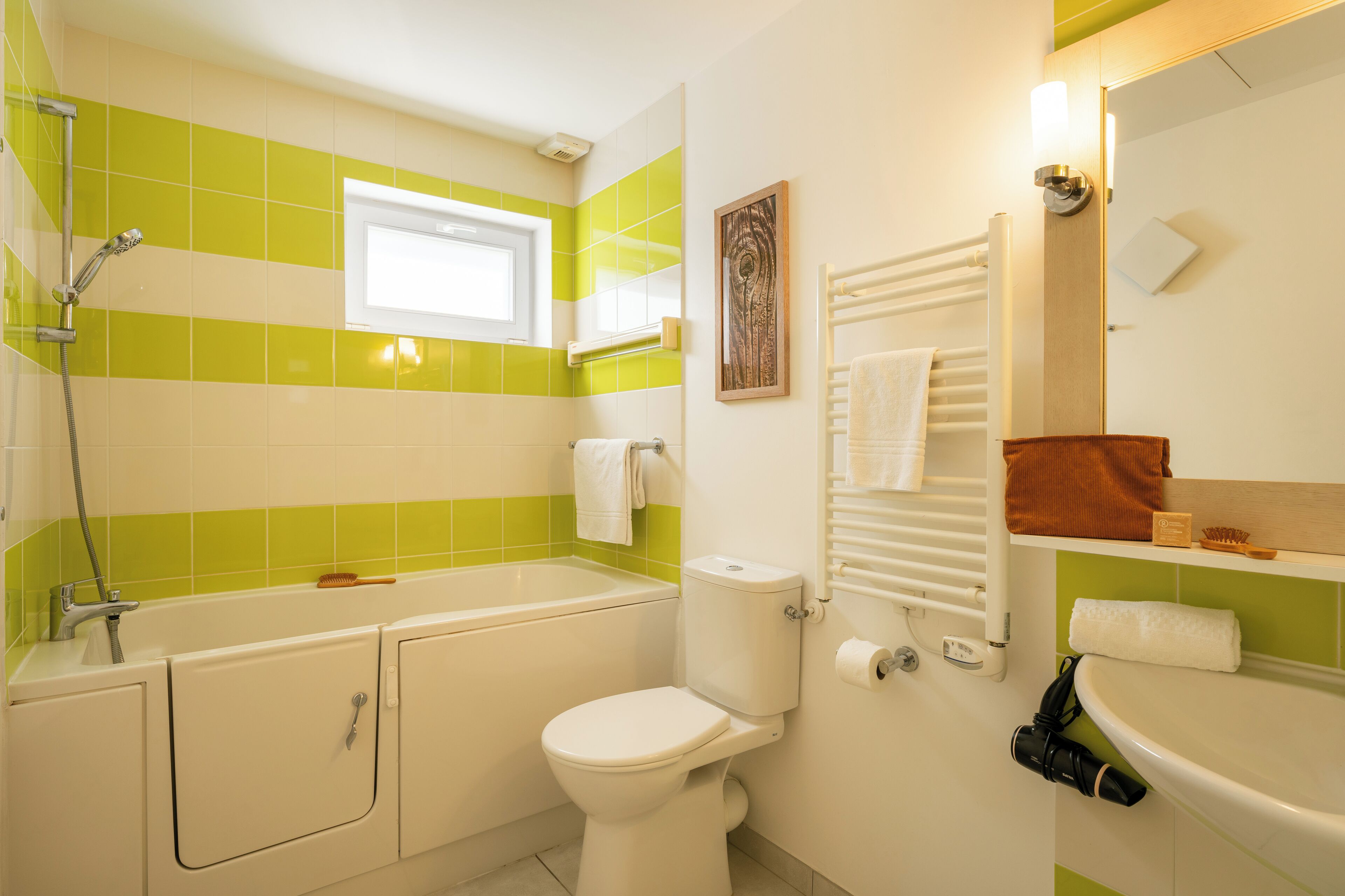 A bathroom with a bathtub, toilet, and sink.