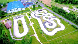 An aerial view of a large parking lot with multiple winding roads and a building with a blue roof. - Aspire Gettysburg Hotel (Gettysburg)