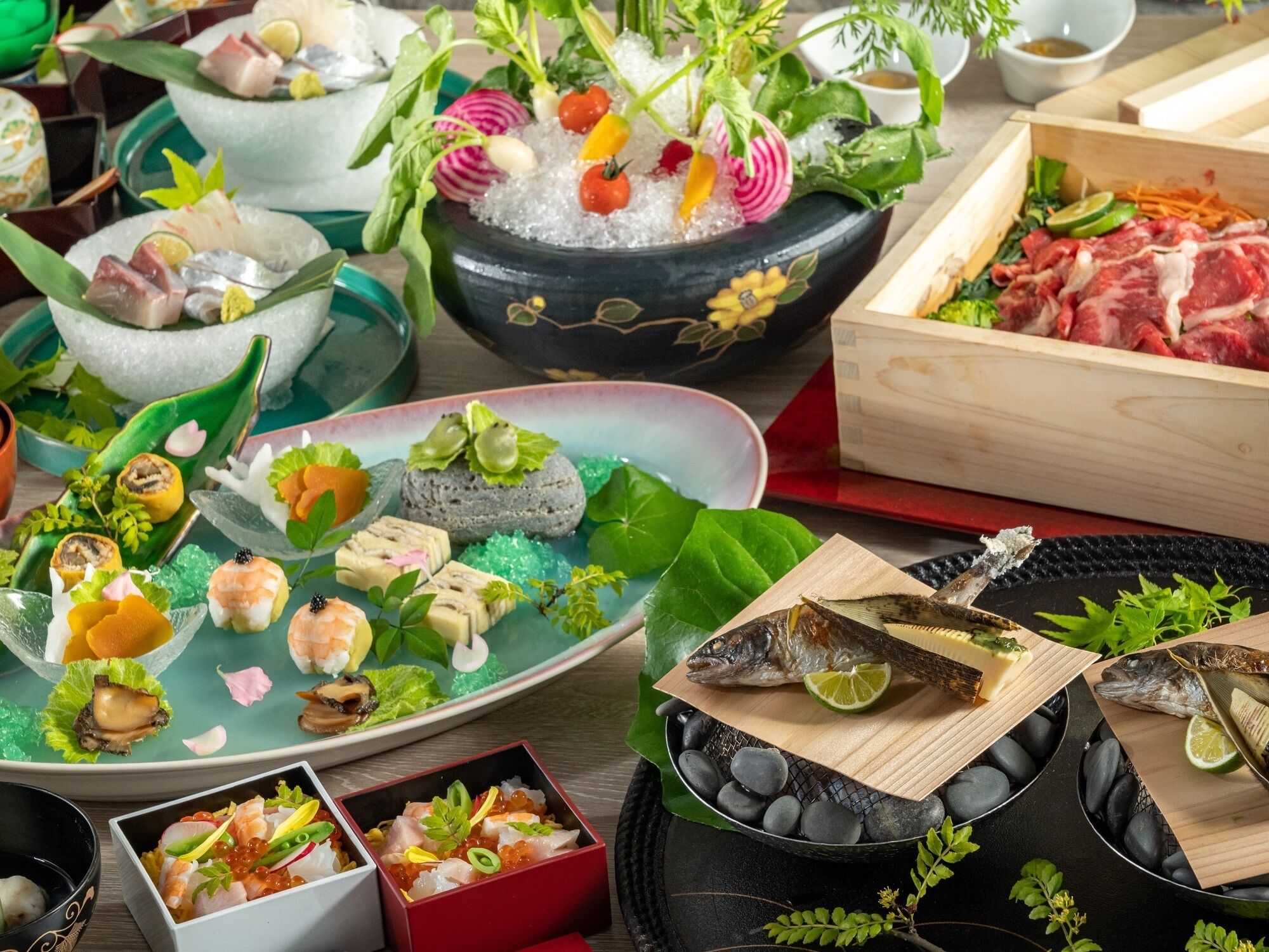 A variety of sushi dishes and raw fish on a wooden table.