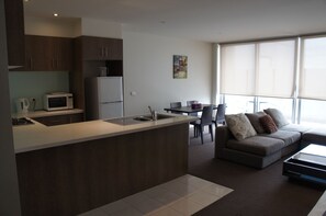 Two Bedroom Economy Apartment | Living room | 42-inch flat-screen TV with cable channels, TV