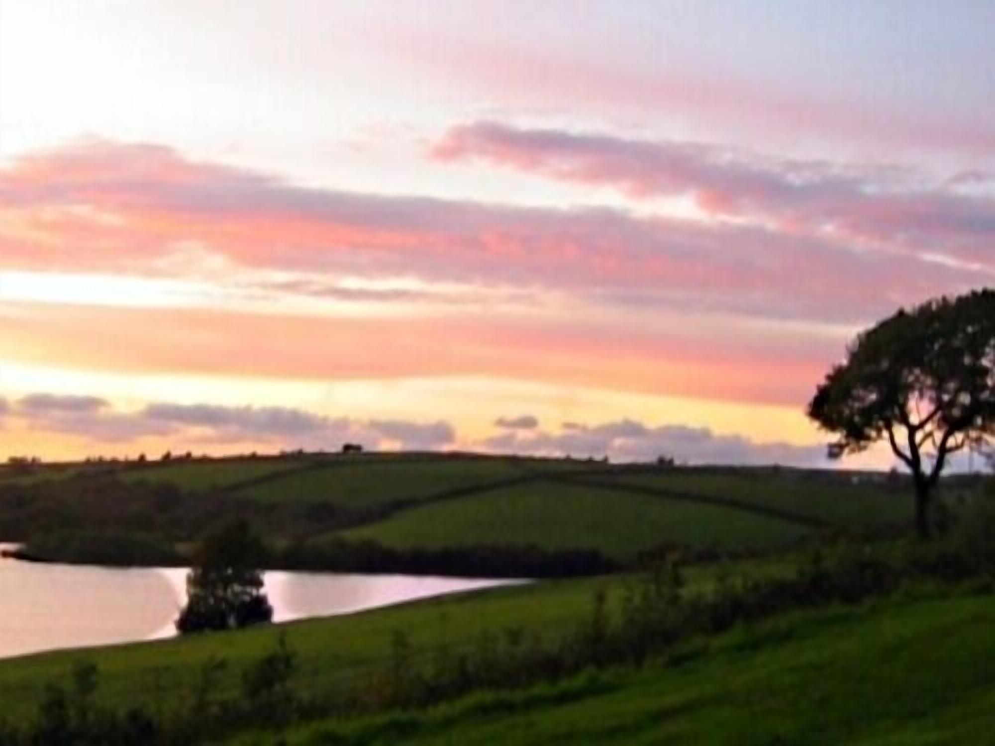 A landscape with rolling hills and a body of water.
