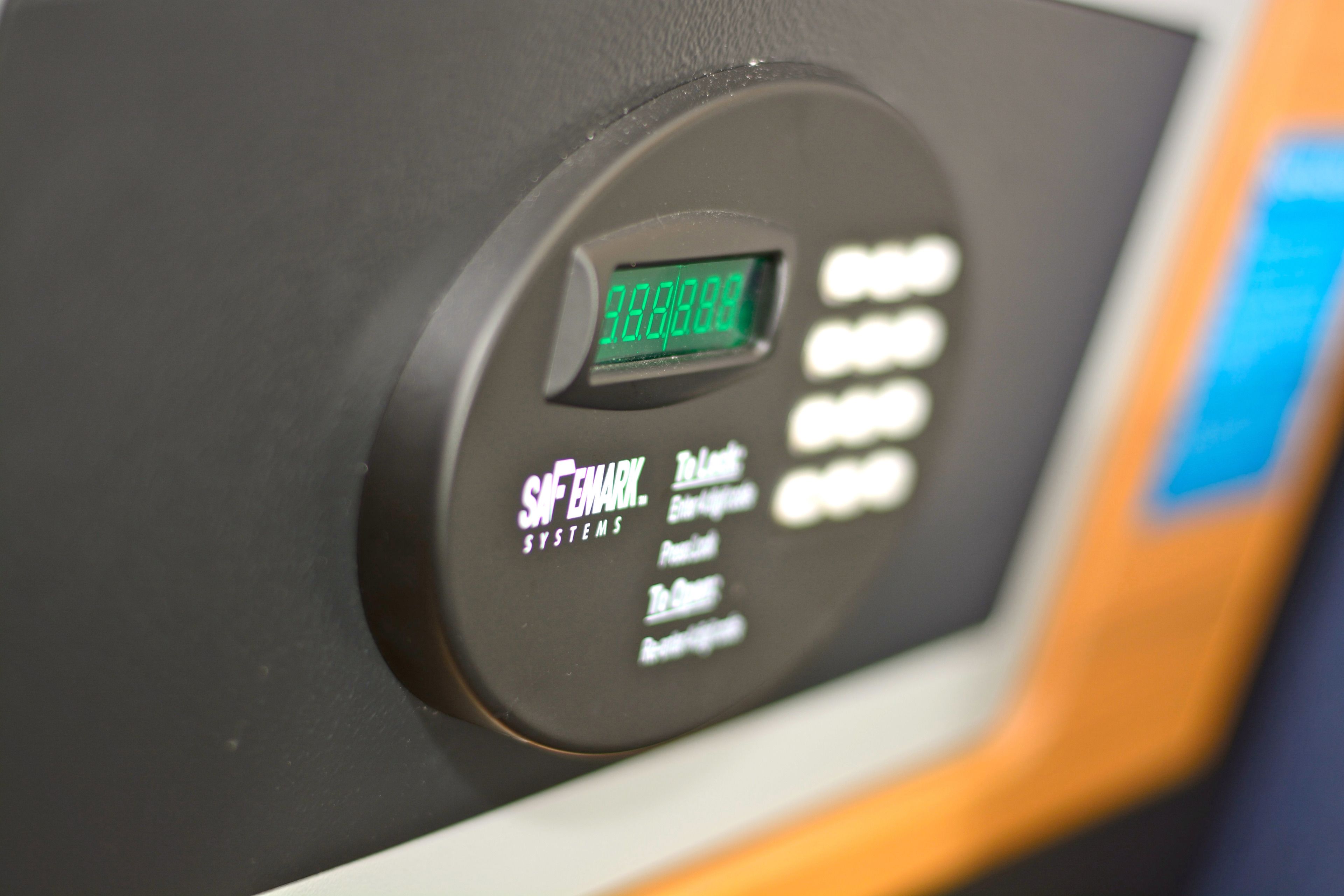 A control panel with a digital display and buttons labeled with various functions.