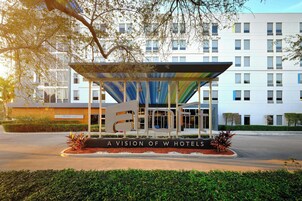 Una entrada de hotel con diseño moderno, que presenta un gran logotipo 'W' y el texto 'A VISION OF W HOTELS'.