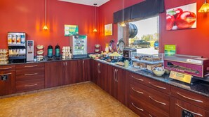 A breakfast bar with a coffee machine, a fruit display, and a sign for fresh pastries. - Quality Inn & Suites Rimbey (Rimbey)