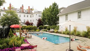 A backyard with a swimming pool, lounge chairs, and a hot tub. - The Red Lion Inn (Stockbridge)