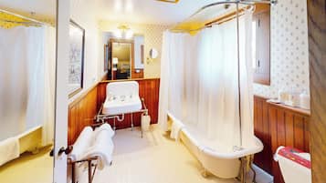 A traditional bathroom with a bathtub, a sink, and a toilet.