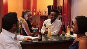 A bar area with a counter, bottles, and glasses. - Haimi Apartment Hotel (Addis Ababa)