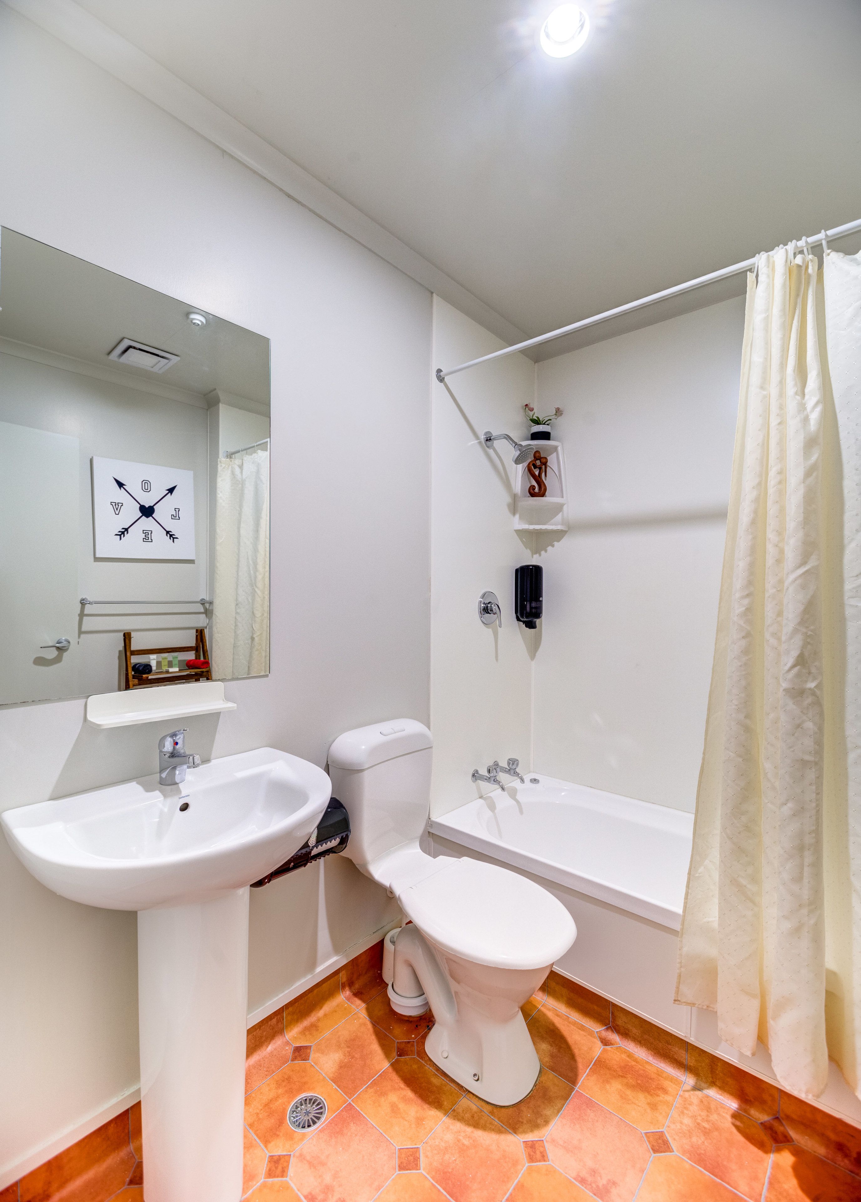 A bathroom with a sink, toilet, and bathtub.