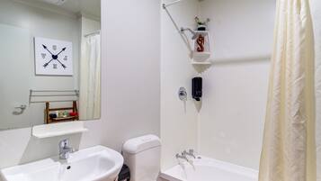A bathroom with a sink, toilet, and bathtub.