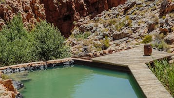 2 outdoor pools, a natural pool, pool umbrellas, pool loungers