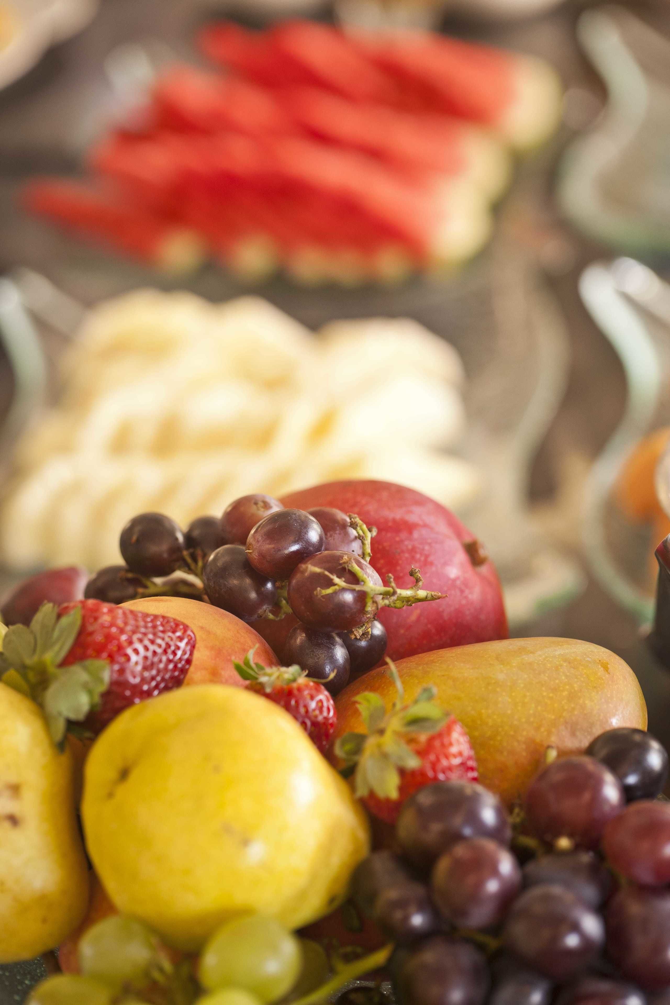 A variety of fruits including strawberries, grapes, and apples.
