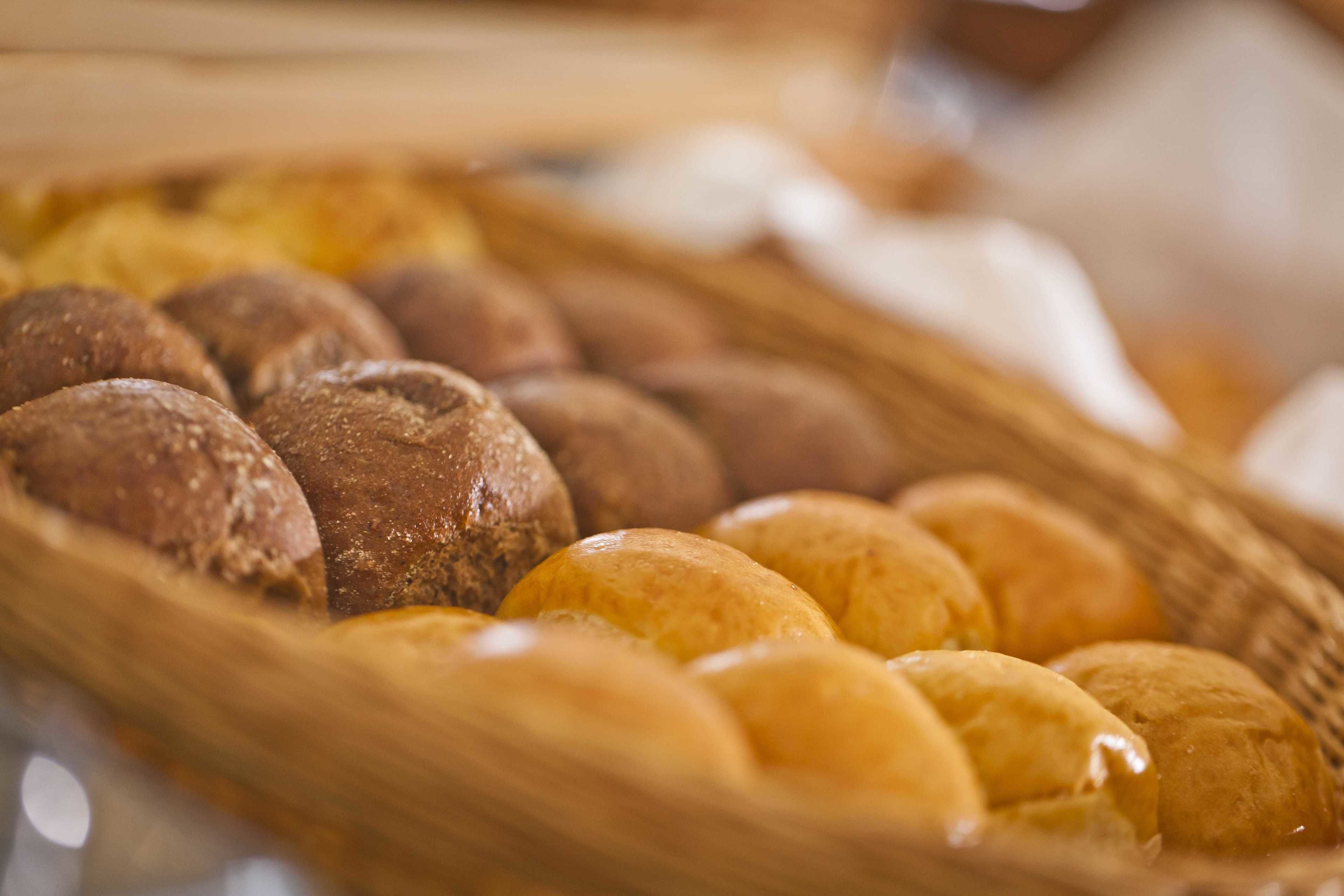 A basket of various breads, including whole grain and white loaves.